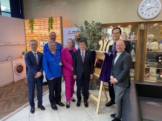 Participants pose with plaque