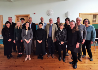 With participants of the OJA-sponsored social event. Front centre is OJA Chair Macrae. In the back, far right, is OJA Vice President Ruta Noreika.